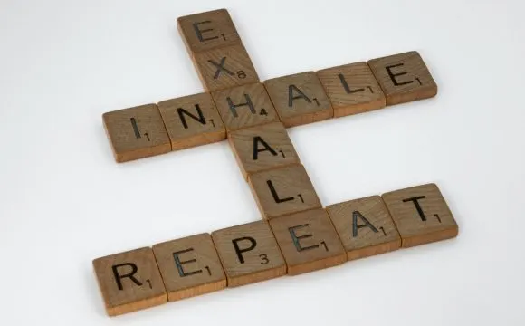 brett-jordan-osYax0ZmZRk-unsplash | Tel Aviv Doctor Scrabble tiles spelling “inhale, exhale, repeat” — a breathing and stress-relief motif
