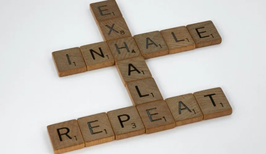 brett-jordan-osYax0ZmZRk-unsplash | Tel Aviv Doctor Scrabble tiles spelling “inhale, exhale, repeat” — a breathing and stress-relief motif